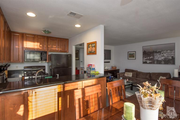 1718 Sinaloa Road, Unit 117 Simi Valley, CA 93065 - Photo 12 of 23 a kitchen with stainless steel appliances a sink counter top space and a window