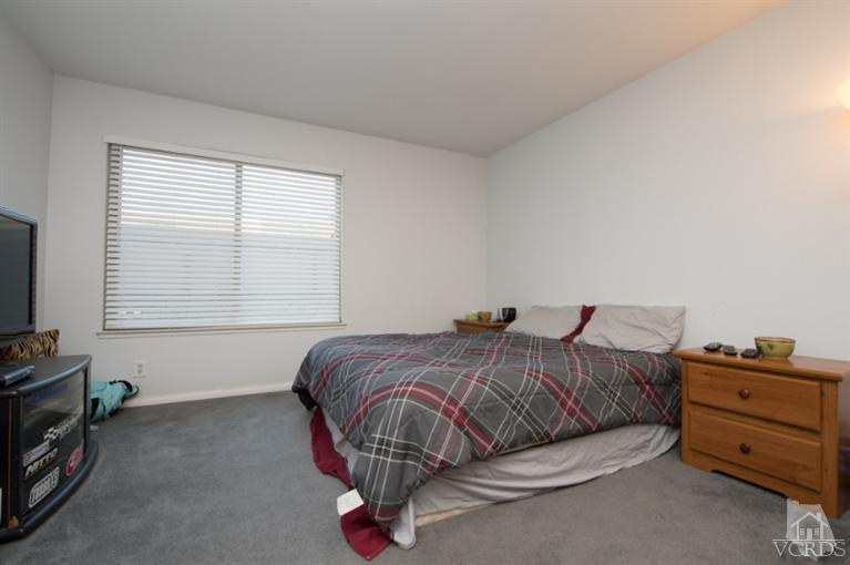 1718 Sinaloa Road, Unit 117 Simi Valley, CA 93065 - Photo 15 of 23 a bedroom with a bed and a window
