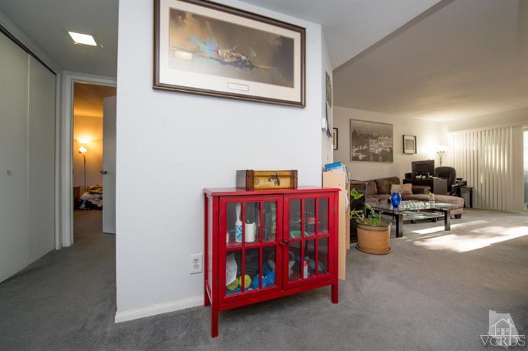 1718 Sinaloa Road, Unit 117 Simi Valley, CA 93065 - Photo 3 of 23 a living room with furniture and a baby crib