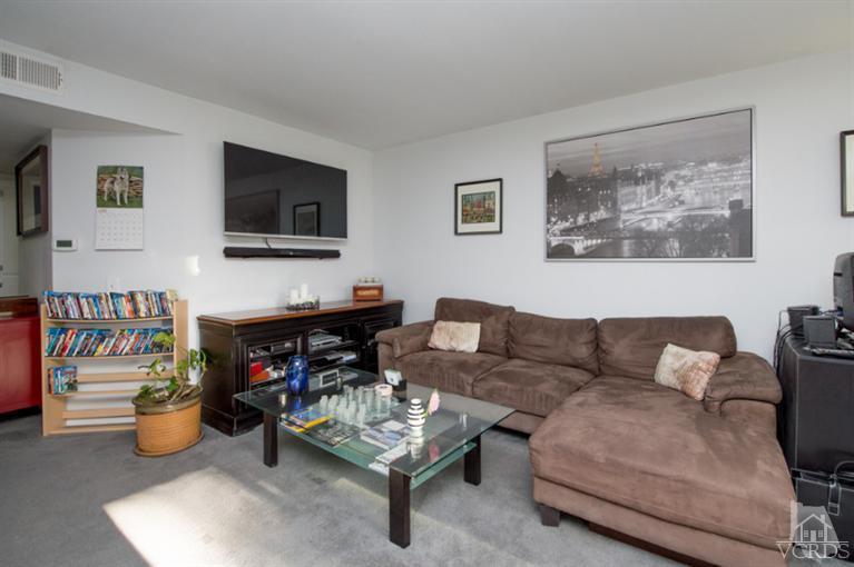 1718 Sinaloa Road, Unit 117 Simi Valley, CA 93065 - Photo 5 of 23 a living room with furniture and a flat screen tv