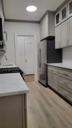 a kitchen with stainless steel appliances a refrigerator sink and cabinets