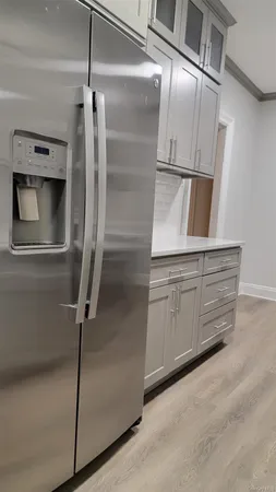 a kitchen with white cabinets and white stainless steel appliances