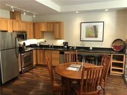 a kitchen with granite countertop a sink stove and refrigerator