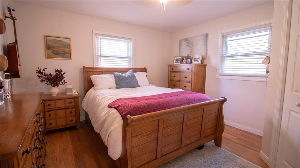 130 Waltz Mill Road Ruffs Dale, PA 15679 - Photo 15 of 34 a spacious bedroom with a bed and a flat tv screen on dresser