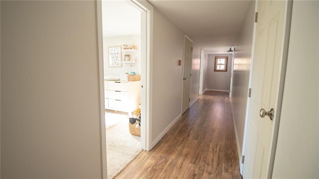 130 Waltz Mill Road Ruffs Dale, PA 15679 - Photo 17 of 34 a view of a hallway with wooden floor