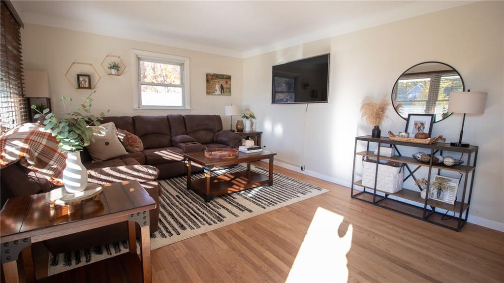 130 Waltz Mill Road Ruffs Dale, PA 15679 - Photo 7 of 34 a living room with furniture a flat screen tv and a window