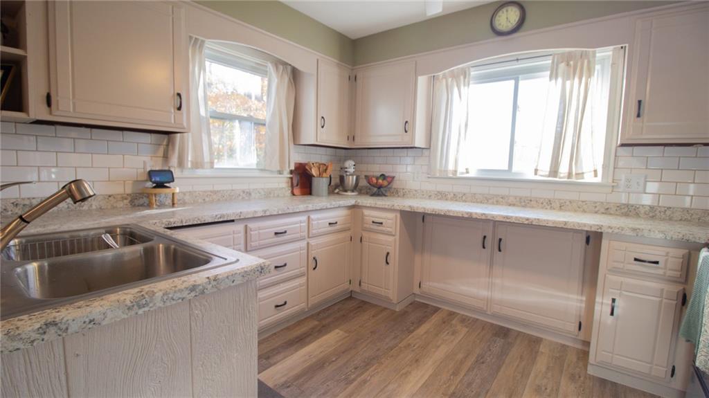 130 Waltz Mill Road Ruffs Dale, PA 15679 - Photo 8 of 34 a kitchen with white cabinets appliances a sink and a window