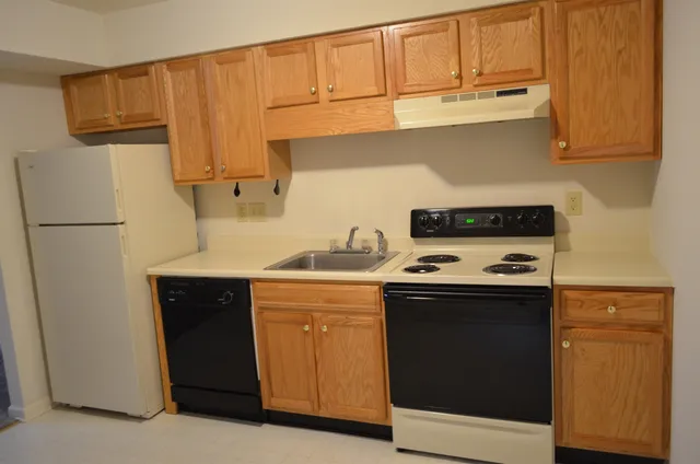 a kitchen with a sink a stove and a refrigerator