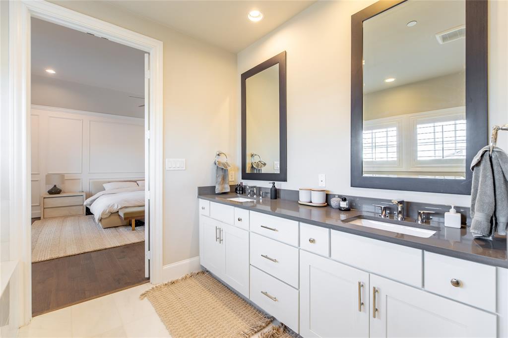 4116 Runyon Road Addison, TX 75001 - Photo 20 of 31 a en suite bathroom with double vanity and a mirror