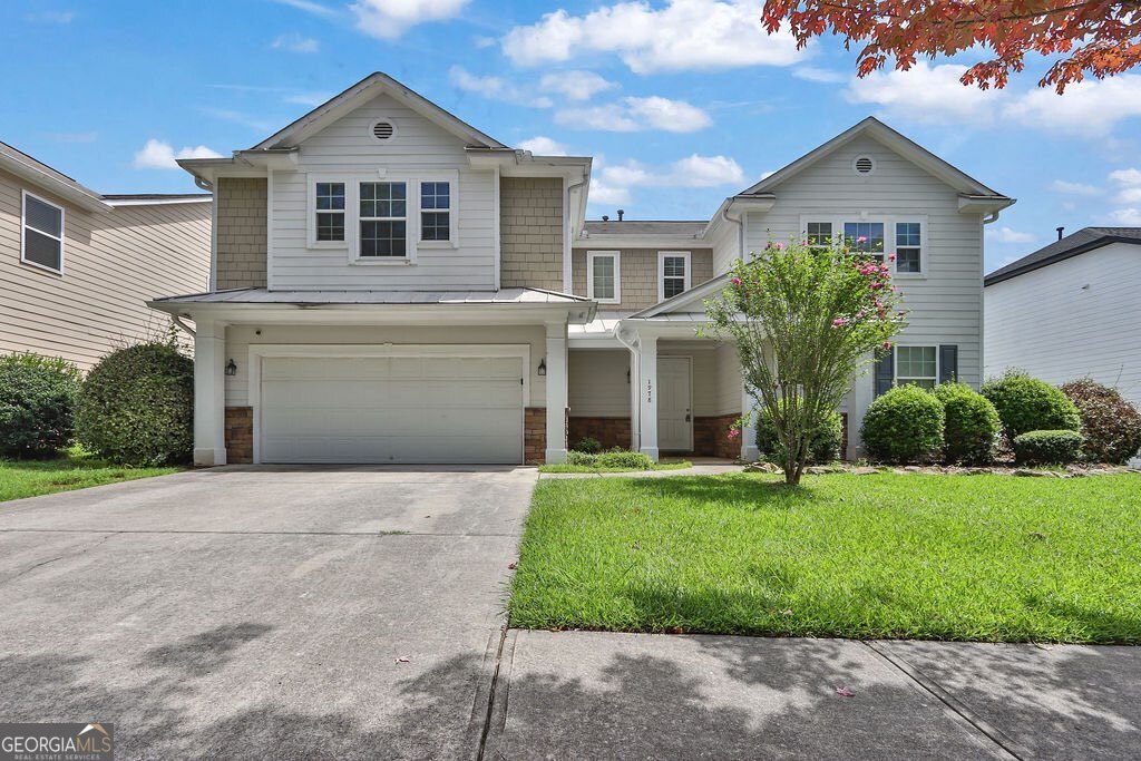 1978 Cutleaf Creek Road Southeast Grayson, GA 30017 - Photo 1 of 1 a front view of a house with a yard and garage
