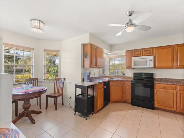 a kitchen with a sink and chairs