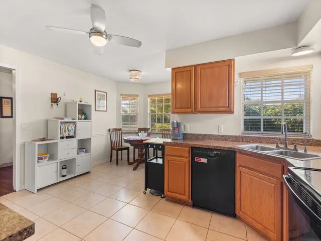 a kitchen with stainless steel appliances granite countertop a sink and cabinets