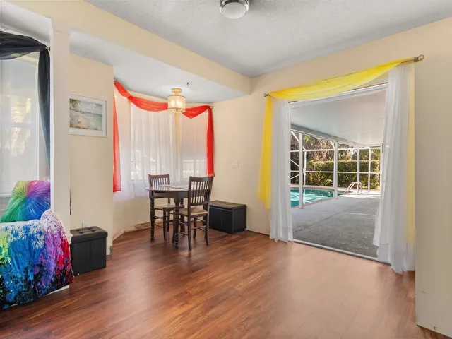 a view of a dining room with furniture window and wooden floor
