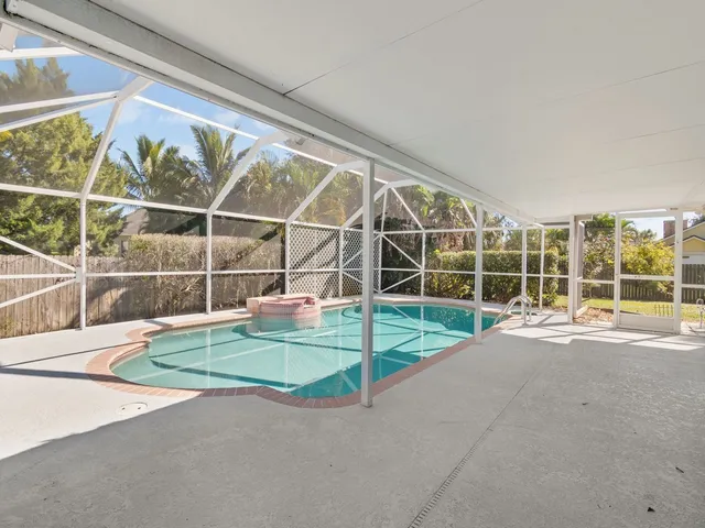a view of an empty room with a floor to ceiling window