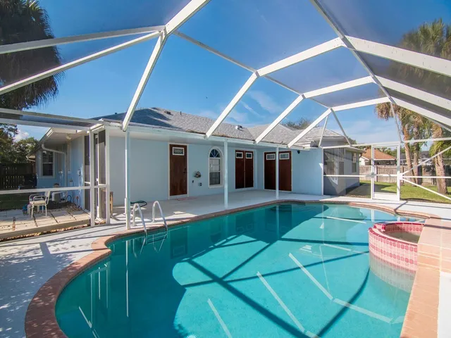 a view of a patio with table and chairs under an umbrella