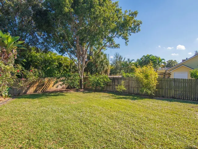 a view of a yard with a house in the background
