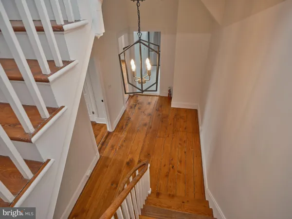 a view of staircase with wooden floor