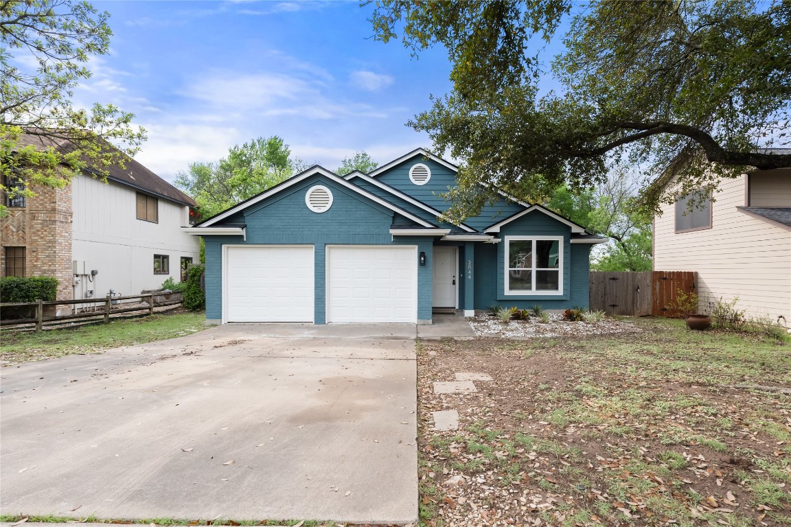 2844 Gettysburg Drive Austin, TX 78745 - Photo 1 of 1 a front view of a house with a yard and a garage