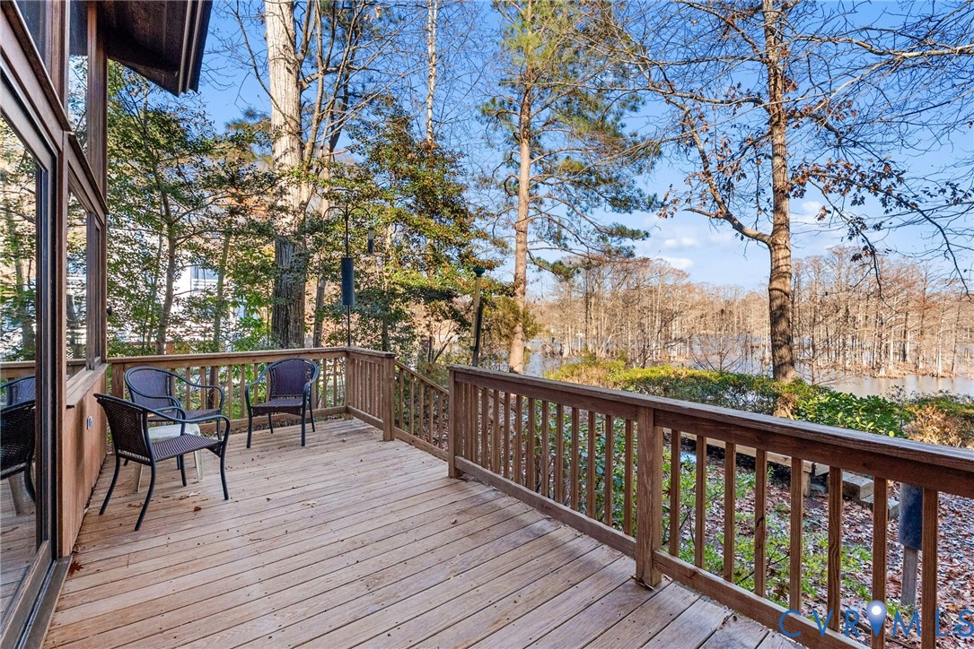 701 Colony Trail Lanexa, VA 23089 - Photo 18 of 50 a view of a deck with table and chairs and wooden floor