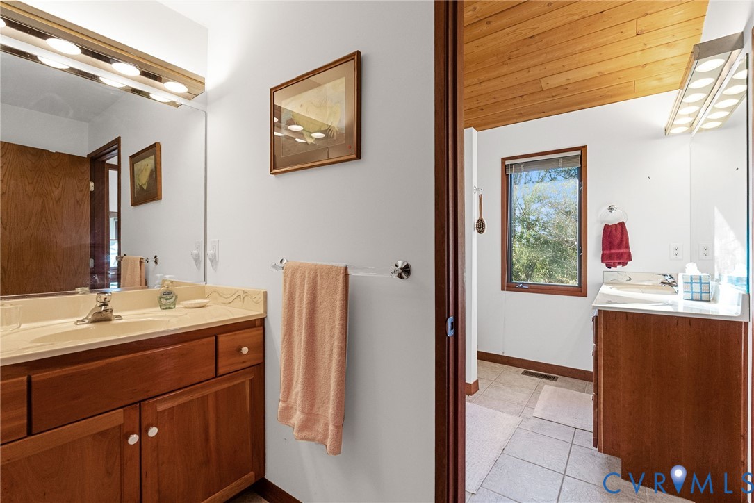 701 Colony Trail Lanexa, VA 23089 - Photo 44 of 50 a bathroom with a sink and a mirror