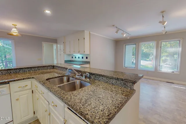 a kitchen with refrigerator and cabinets