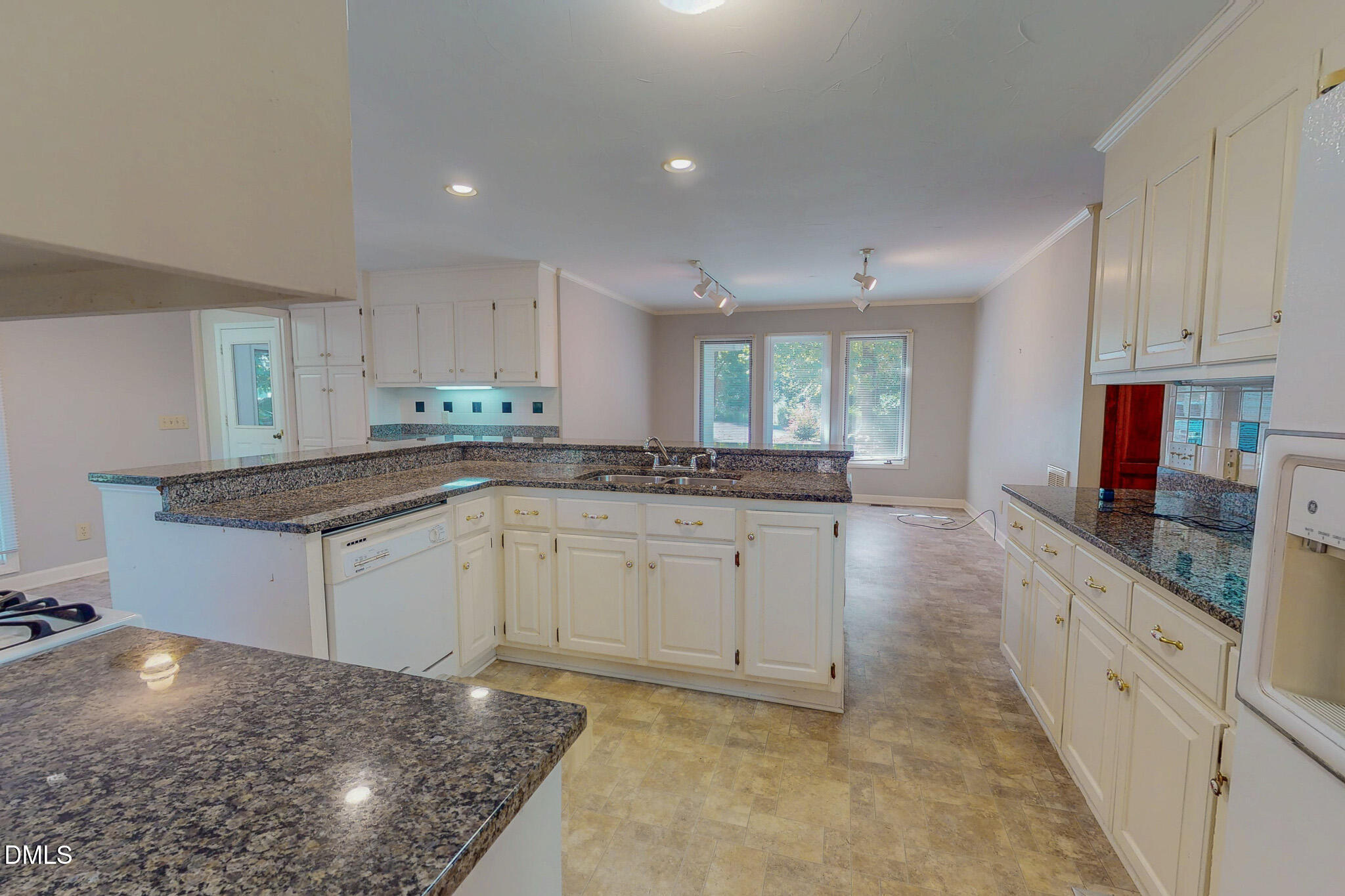 11 Denada Path Roxboro, NC 27574 - Photo 23 of 57 a kitchen with granite countertop a sink and white cabinets