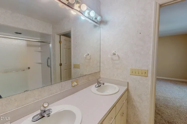 a bathroom with a granite countertop toilet a sink and a mirror