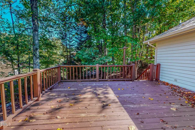 a view of a deck with wooden floor and fence