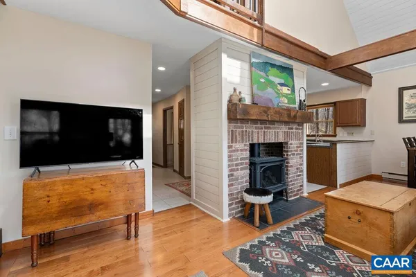 a living room with fireplace furniture and a floor to ceiling window