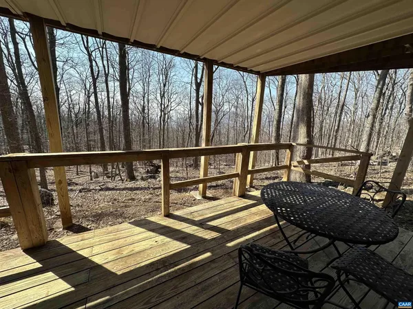 a view of balcony with wooden floor and seating space