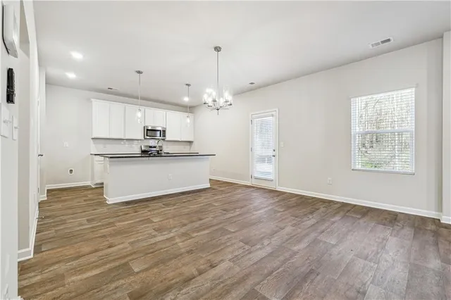 a view of kitchen with granite countertop cabinets and stainless steel appliances
