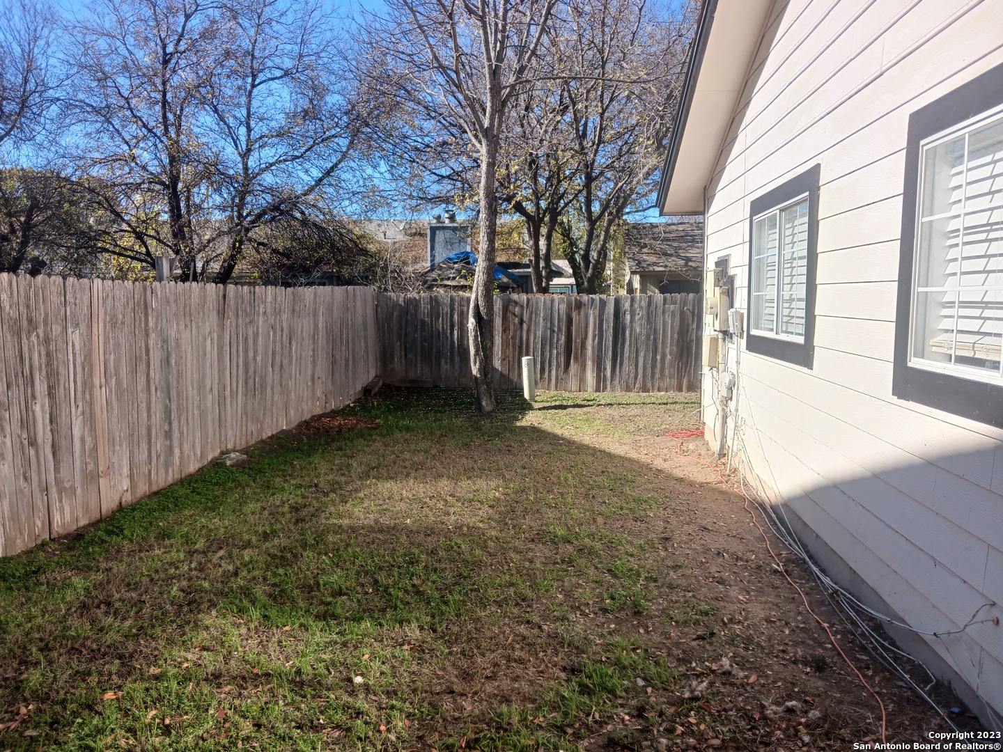 11725 Spring Ridge Drive San Antonio, TX 78249 - Photo 18 of 18 a view of a backyard with wooden fence