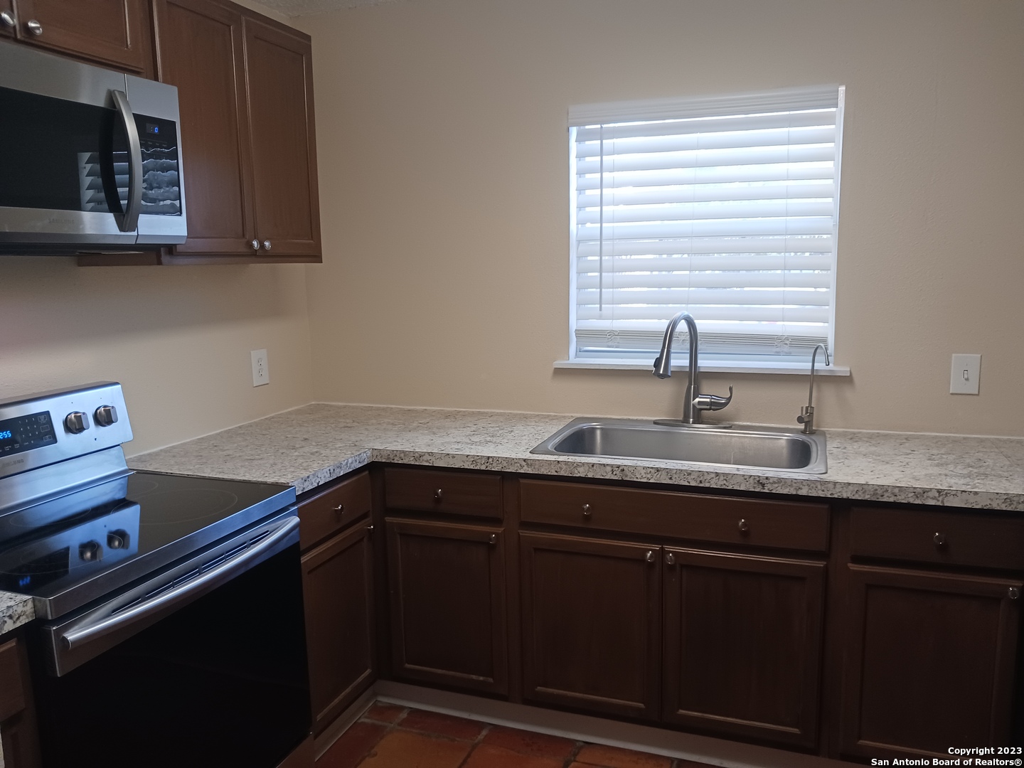 11725 Spring Ridge Drive San Antonio, TX 78249 - Photo 7 of 18 a kitchen with a sink and cabinets