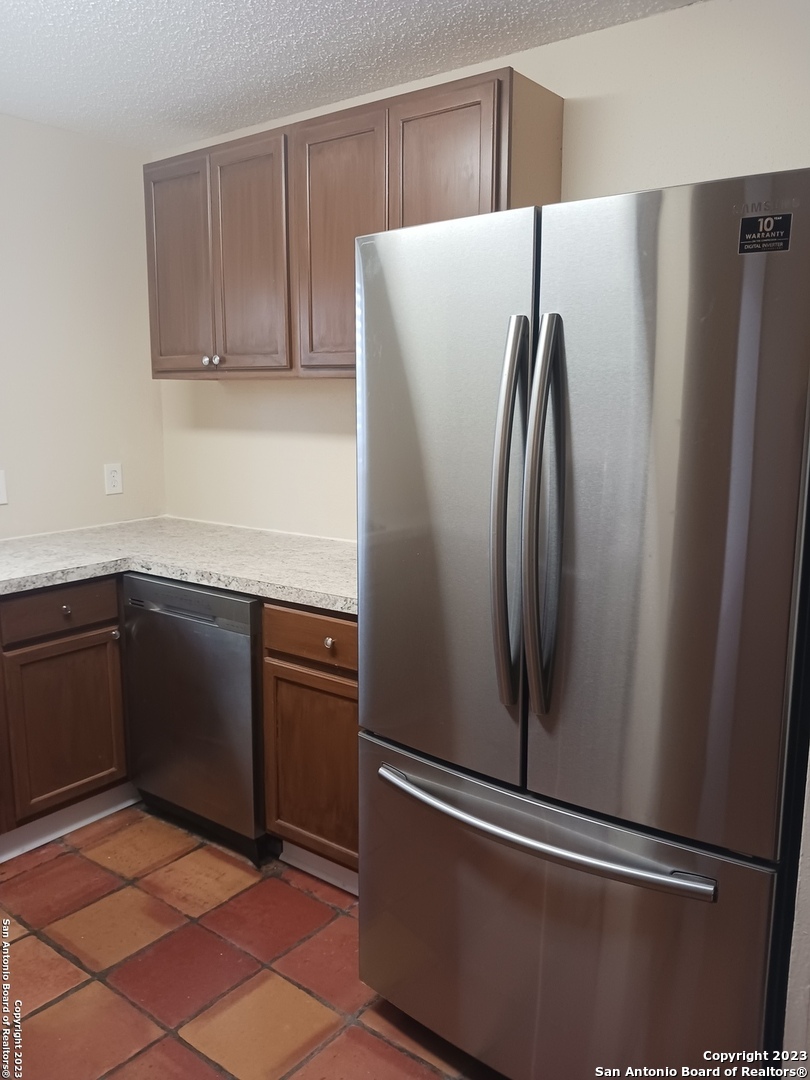 11725 Spring Ridge Drive San Antonio, TX 78249 - Photo 8 of 18 a metallic refrigerator freezer sitting in a kitchen