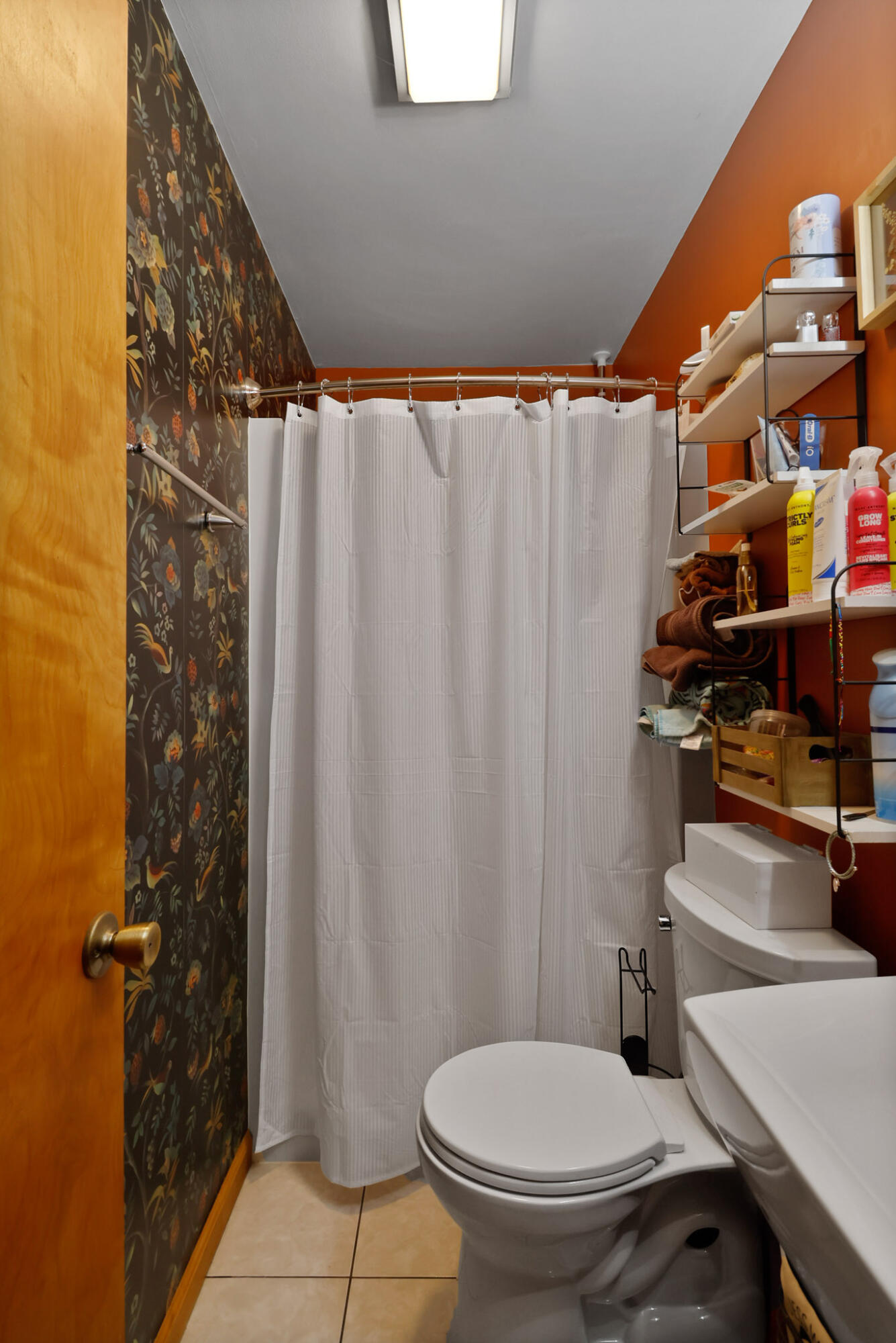 3712 Baldwin Street Portage, IN 46368 - Photo 18 of 26 a white toilet sitting next to a shower curtain