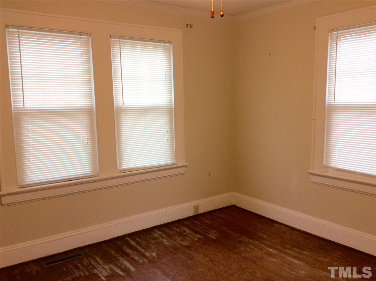 1309 Lake Wheeler Road Raleigh, NC 27603 - Photo 12 of 17 an empty room with wooden floor and windows