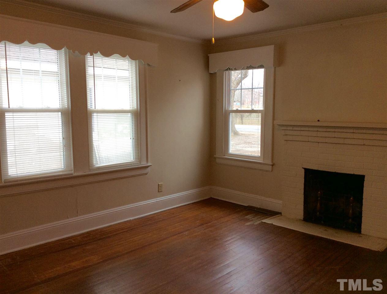 1309 Lake Wheeler Road Raleigh, NC 27603 - Photo 4 of 17 a view of an empty room with wooden floor and a window
