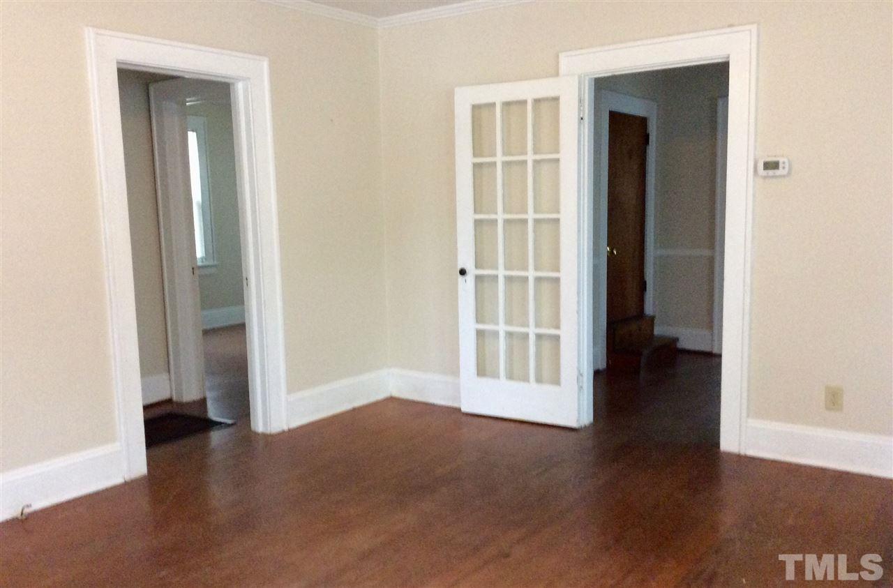 1309 Lake Wheeler Road Raleigh, NC 27603 - Photo 5 of 17 an empty room with wooden floor and windows