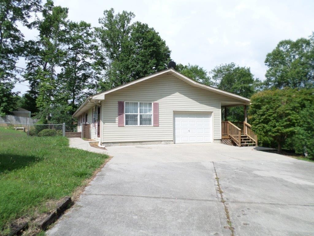 10705 McBee Mill Road Corryton, TN 37721 - Photo 18 of 20 a view of house with a yard and potted plants