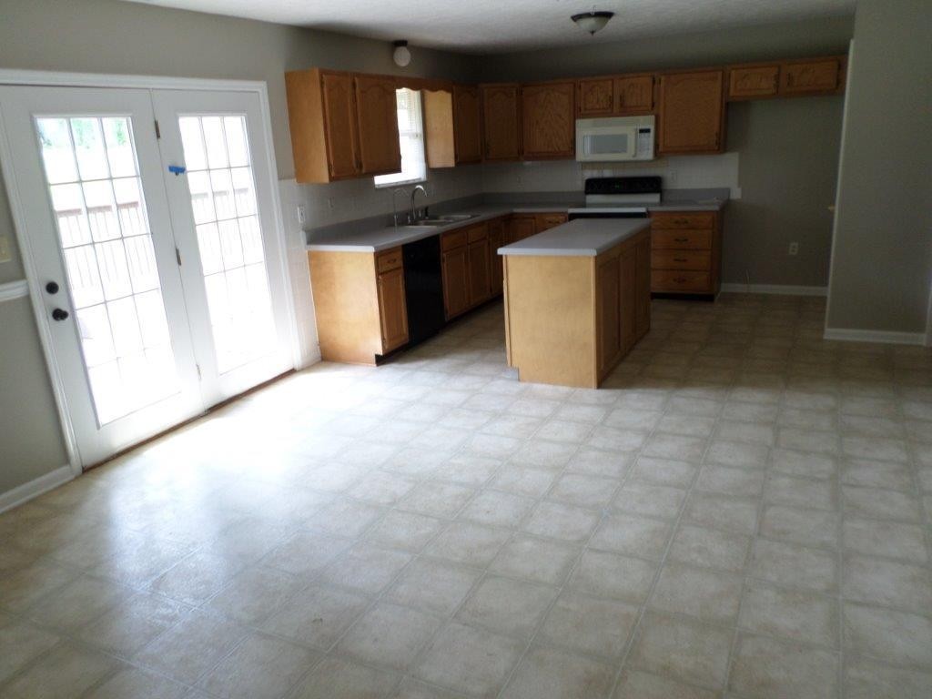 10705 McBee Mill Road Corryton, TN 37721 - Photo 3 of 20 a kitchen with stainless steel appliances granite countertop a stove a sink and a refrigerator