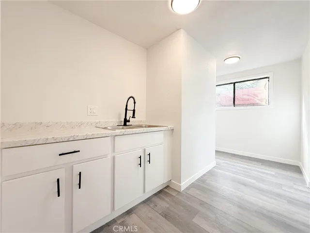 a view of a kitchen with sink and window