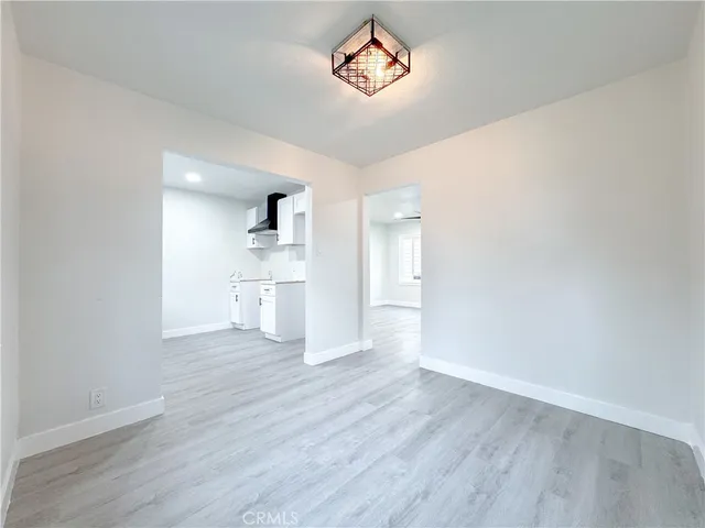 a view of a kitchen with wooden floor and a window