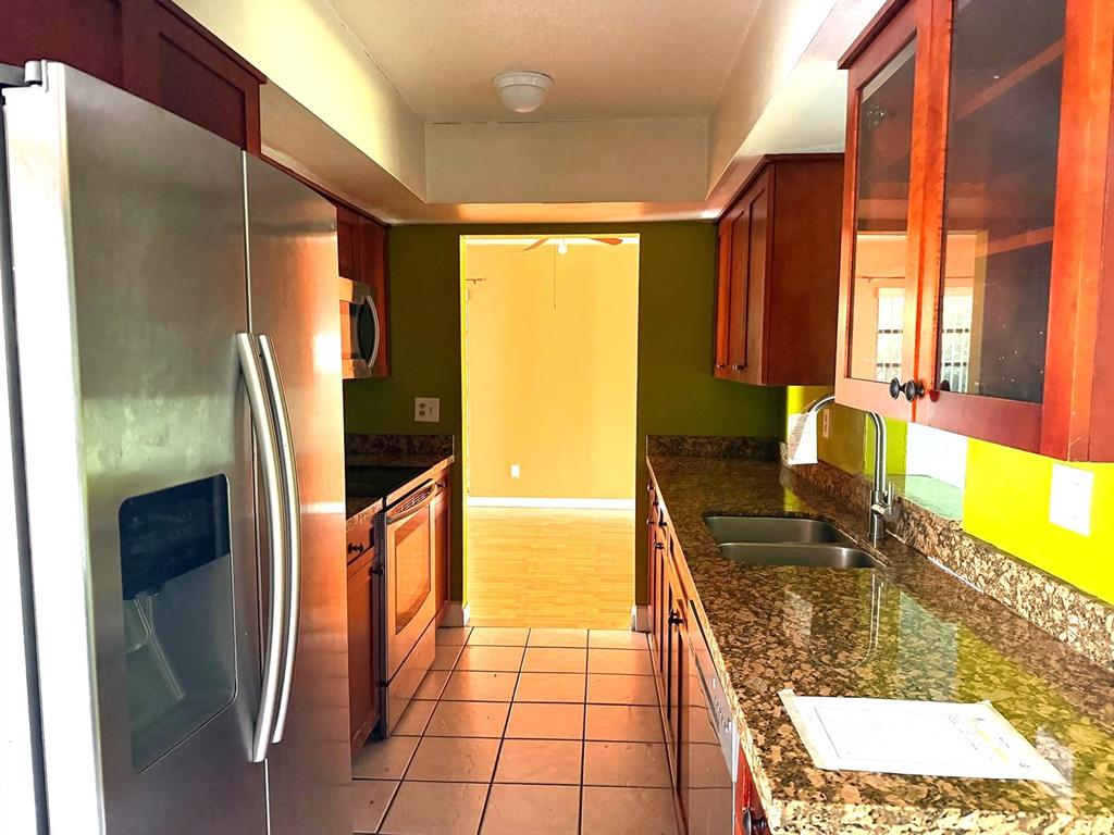 7101 Northwest 68th Street Tamarac, FL 33321 - Photo 5 of 12 a bathroom with a granite countertop sink and a large mirror