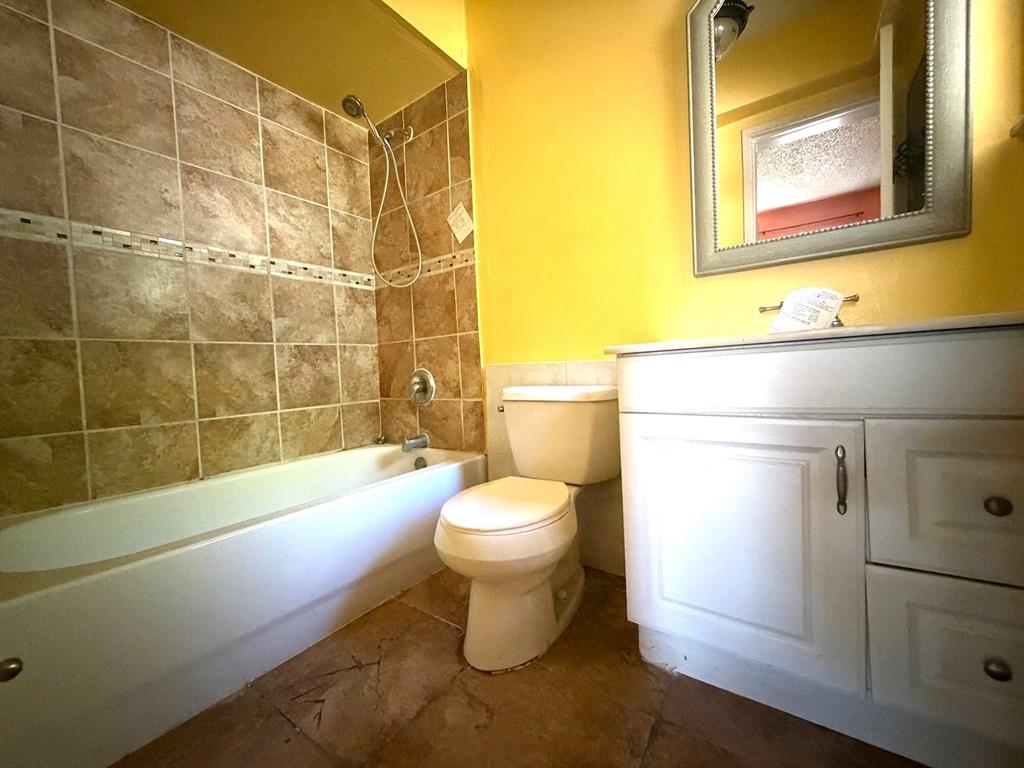 7101 Northwest 68th Street Tamarac, FL 33321 - Photo 7 of 12 a bathroom with a toilet and a shower