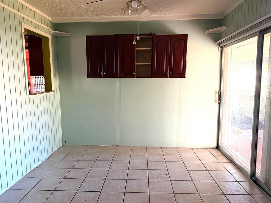 7101 Northwest 68th Street Tamarac, FL 33321 - Photo 9 of 12 a view of an empty room with cabinet and wooden floor