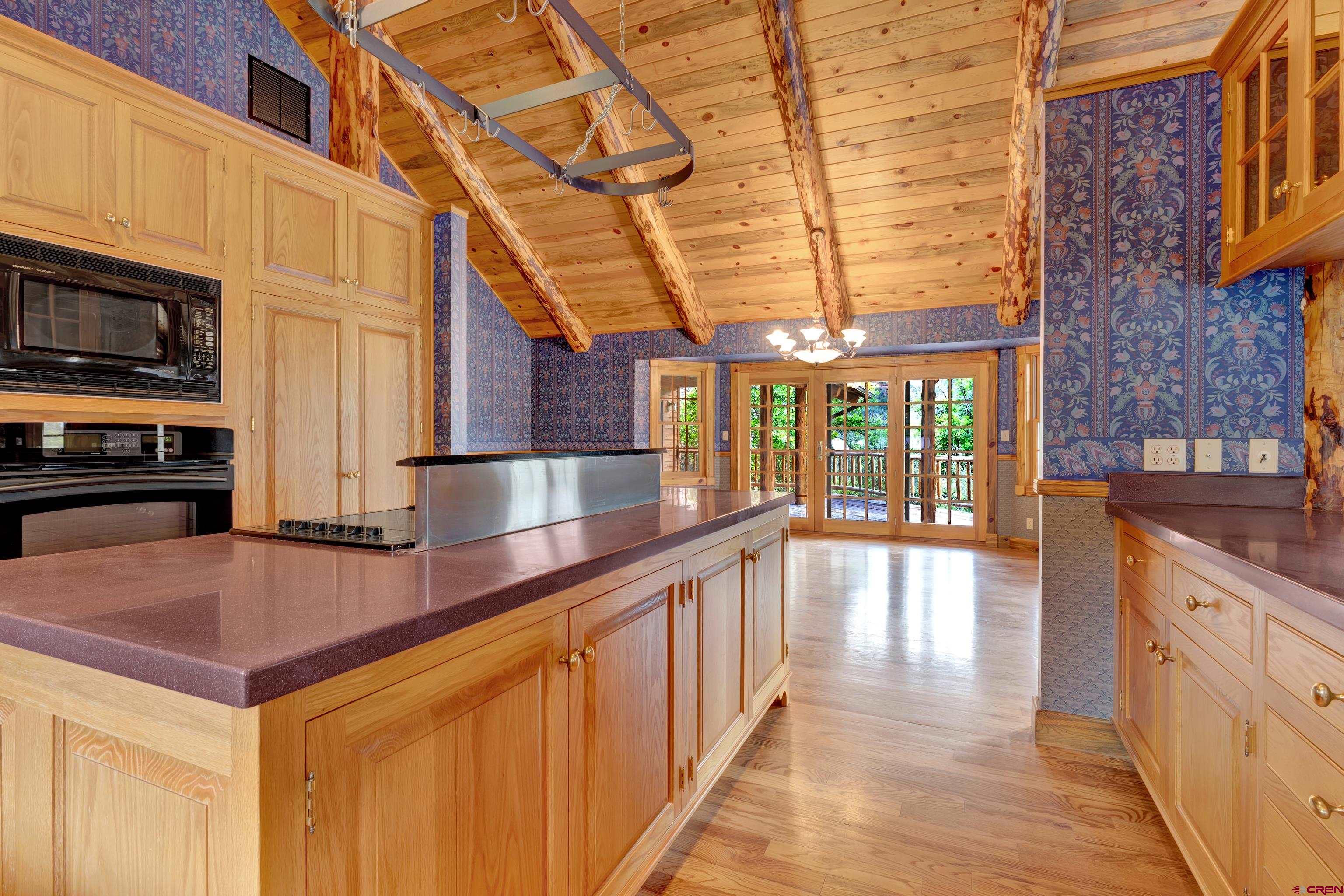 2692 County Road 17 Ridgway, CO 81432 - Photo 12 of 38 a view of a kitchen with stainless steel appliances wooden floor and a large window
