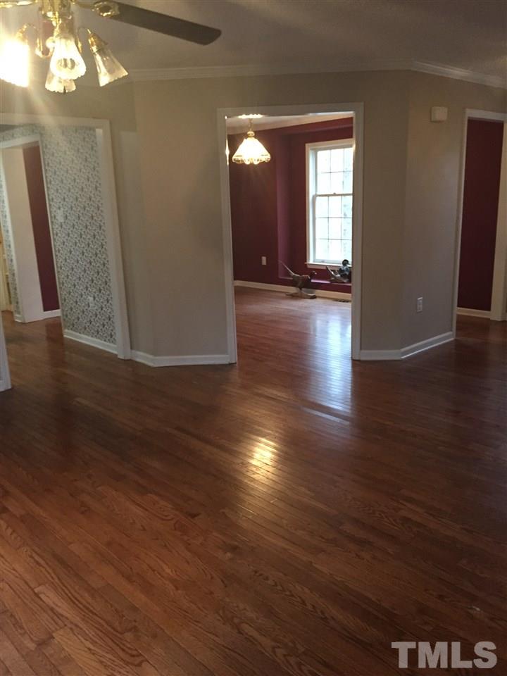 241 Shannon Road Timberlake, NC 27583 - Photo 14 of 17 an empty room with wooden floor and windows