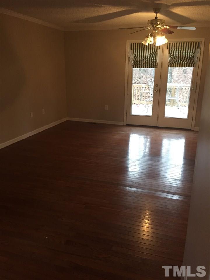 241 Shannon Road Timberlake, NC 27583 - Photo 16 of 17 a view of a livingroom with wooden floor and a window