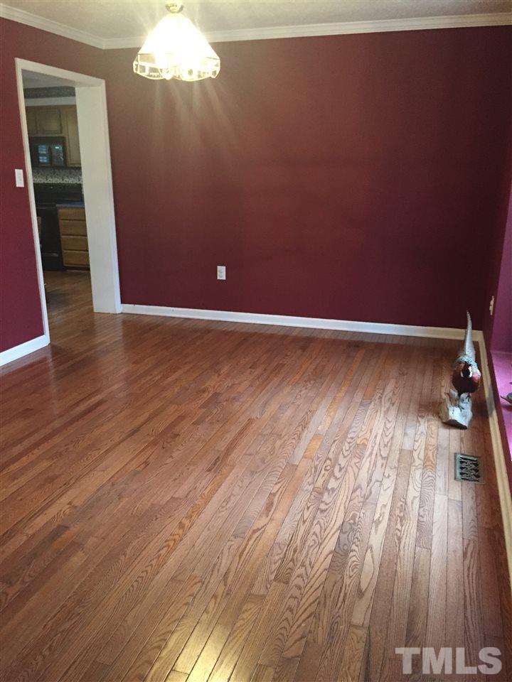 241 Shannon Road Timberlake, NC 27583 - Photo 17 of 17 a view of a livingroom with wooden floor and staircase