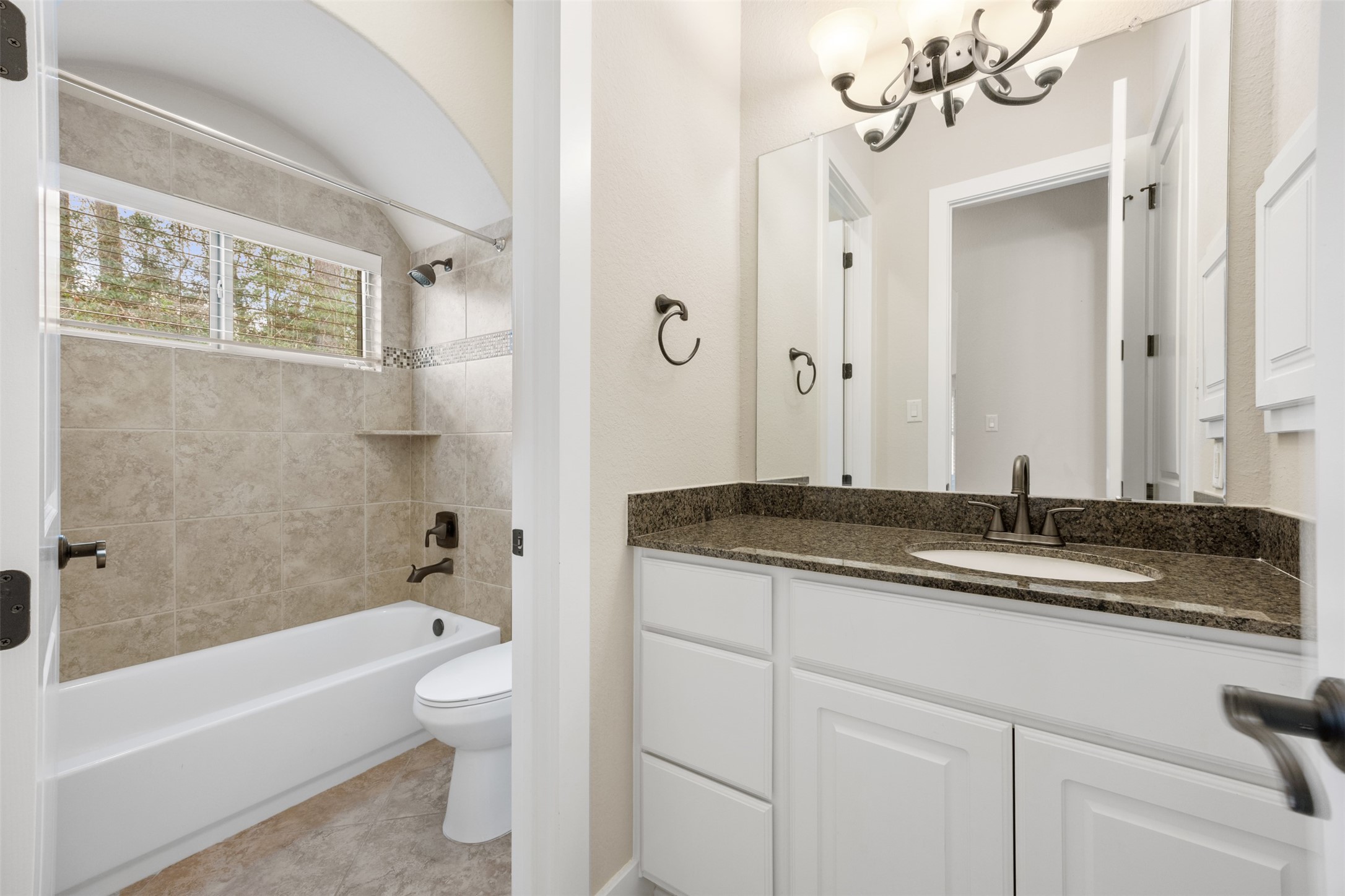 6515 Fraser Point Spring, TX 77379 - Photo 13 of 39 a bathroom with a granite countertop sink a toilet and bathtub